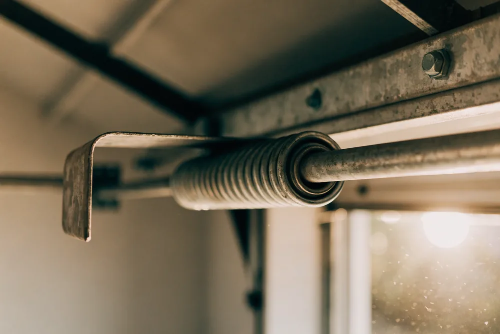 A garage door torsion spring on the header shaft